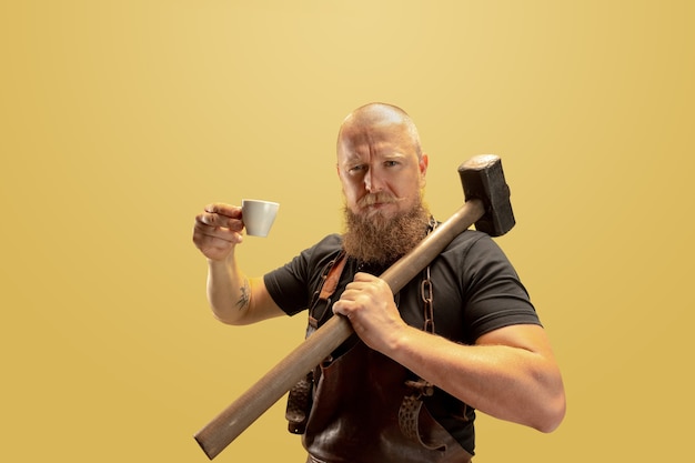 Photo leisure activity comic image of bearded bald man blacksmith leather apron or uniform