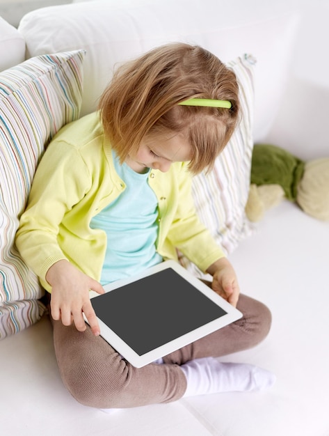 leisure, technology and children concept - little girl with tablet computer at home