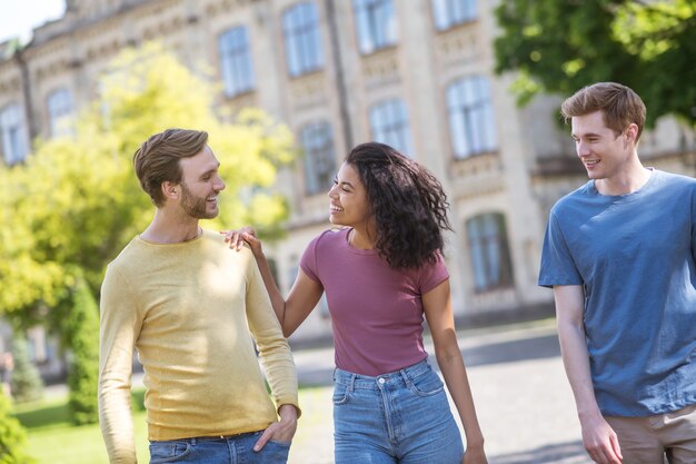 Leisure. Three friends spending time together and smiling nicely