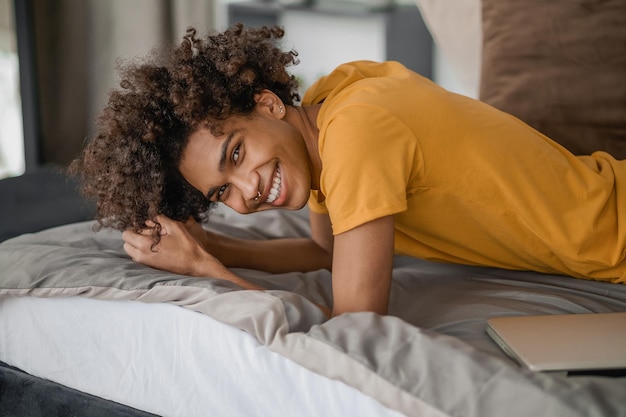 Leisure Young curlyhaired darkskinned man resting at home