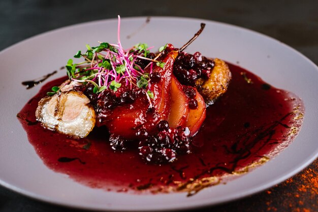 Lekker gerecht met vlees, cranberrysaus en peer op zwarte achtergrond