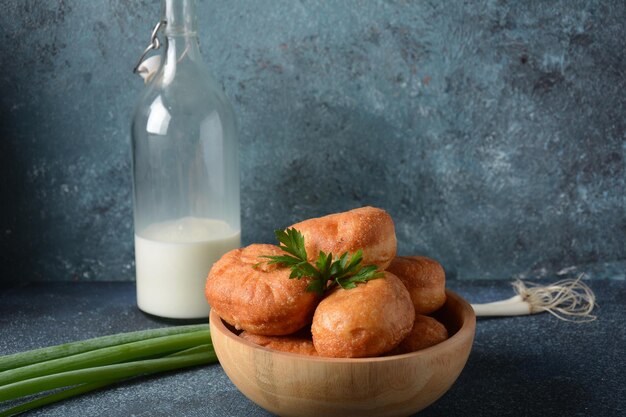 Lekker ontbijt rustieke stijl Gevulde broodjes Pirozhki melk met groene uien