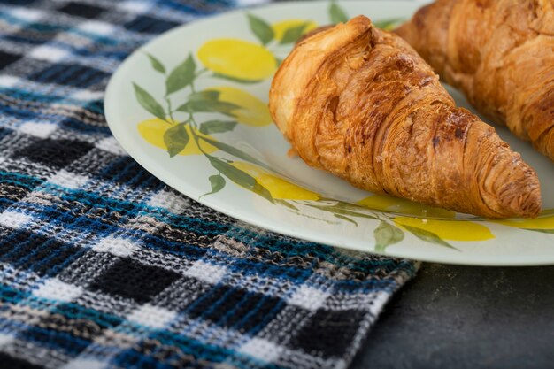 Lekkere boterachtige croissants op een mooi bord.