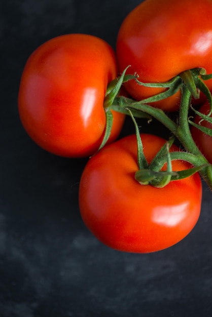 Foto lekkere en verse tomaten op een zwarte stenen serveerplank