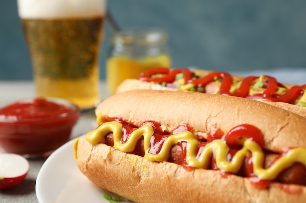 Lekkere hotdogs, bier en frietjes aardappel op grijze tafel