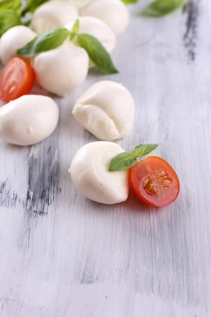 Lekkere mozzarella kaas met basilicum en tomaten op houten tafel