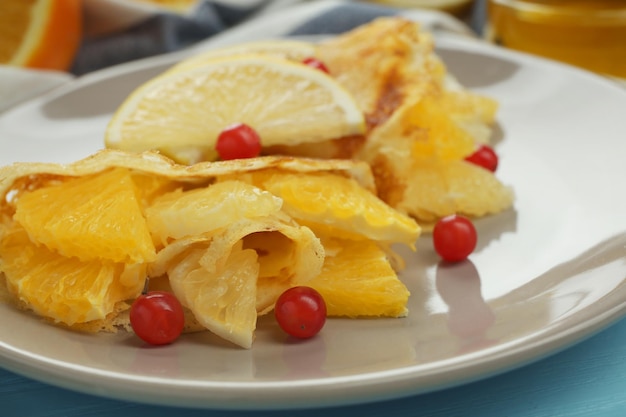 Lekkere pannenkoeken met citrusvruchten op plaat close-up