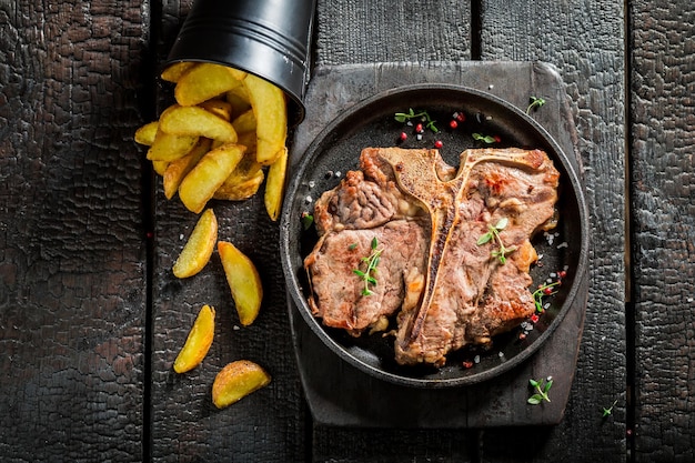 Lekkere tbone steak en patat op de verbrande tafel