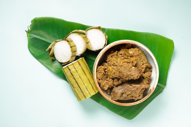 Photo lemang or glutinous rice wrapped with banana leaf is a traditional malay food called juadah raya