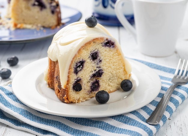 Lemon blueberry cake slice in a plate over wooden table