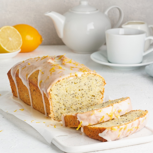 Lemon bread coated with sugar sweet icing and sprinkled with lemon peel.