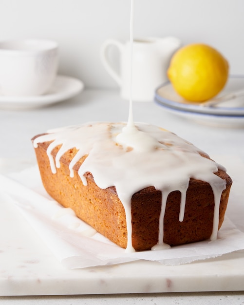 Lemon bread with poppy seeds pouring with white icing sweet morning breakfast