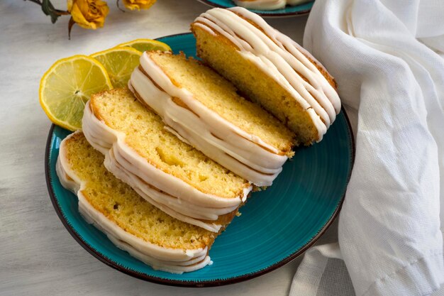 Lemon cake on plate with lemons. Delicious homemade dessert for breakfast.