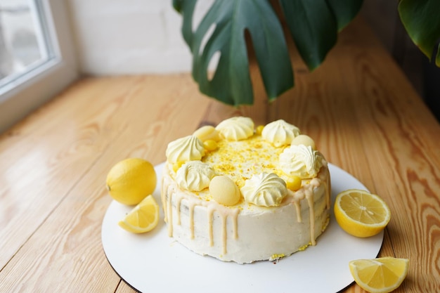 Photo lemon cake on wooden table near window