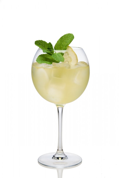 Lemon cocktail with a sparkling wine with ice cubes in wine glass isolated on white