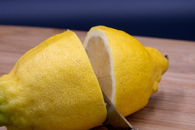 lemon cut on cutting board with black background