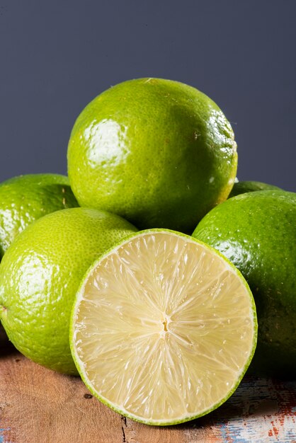 Lemon cut in half with some lemons on wooden table. Lime.