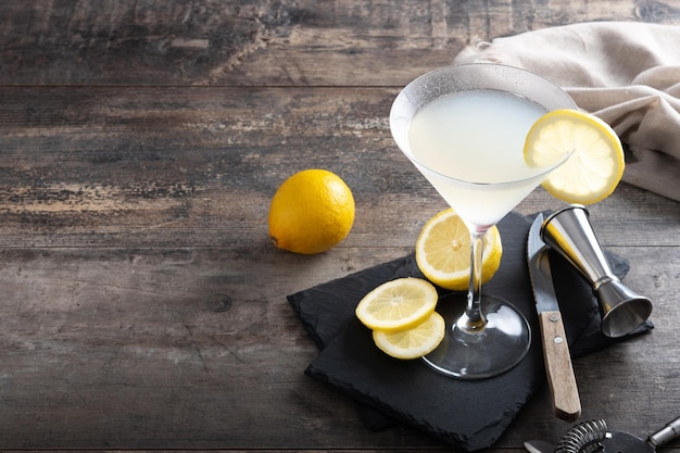 Lemon drop martini cocktail on wooden table