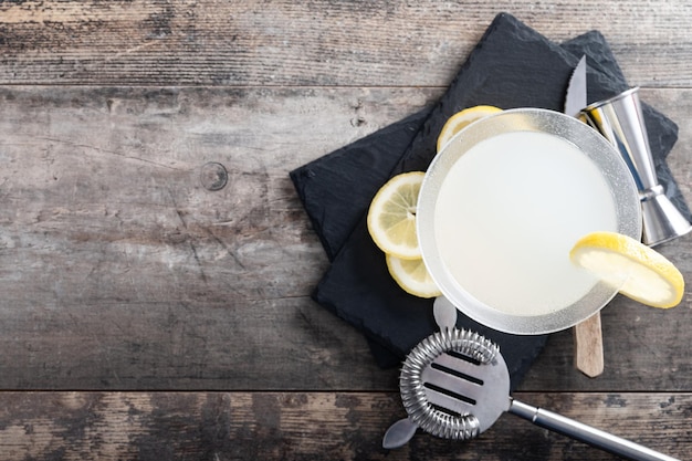 Lemon drop martini cocktail on wooden table