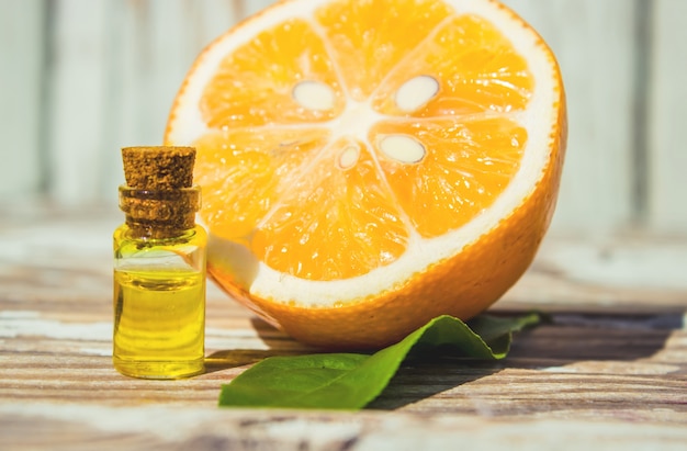 Lemon essential oil in a small bottle. Selective focus.