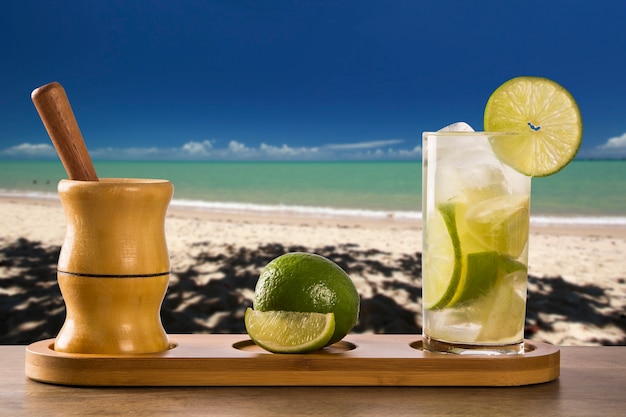 Lemon Fruit Caipirinha of Brazil over beautiful beach