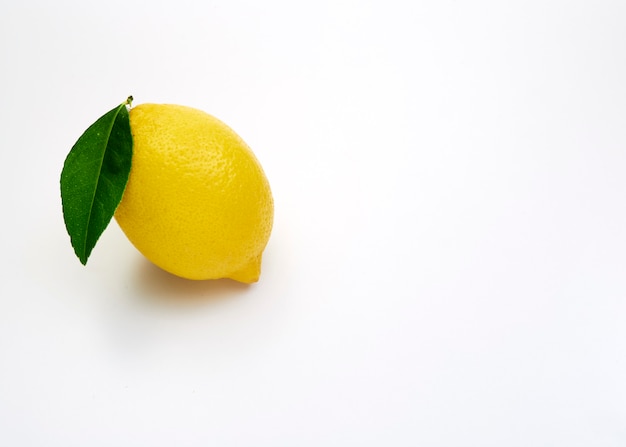 lemon fruit with leaf on white