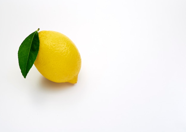 Lemon fruit with leaf on white