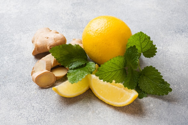 Lemon and ginger root on grey surface 