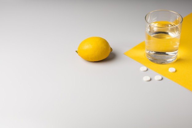 Lemon, a glass of water and medicine