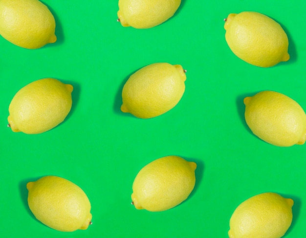 Lemon on the green background Flat lay Pattern Top view