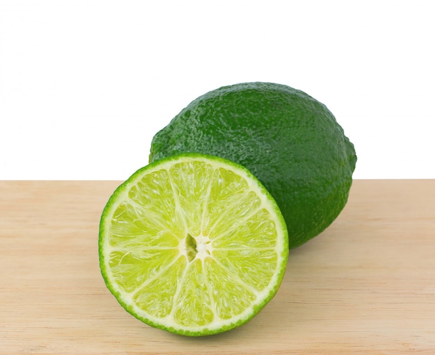 Lemon green slices on wooden table