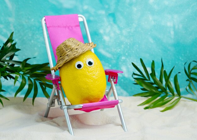 Lemon in hat relaxes on lounge chair on beach summer tropical minimal humor poster