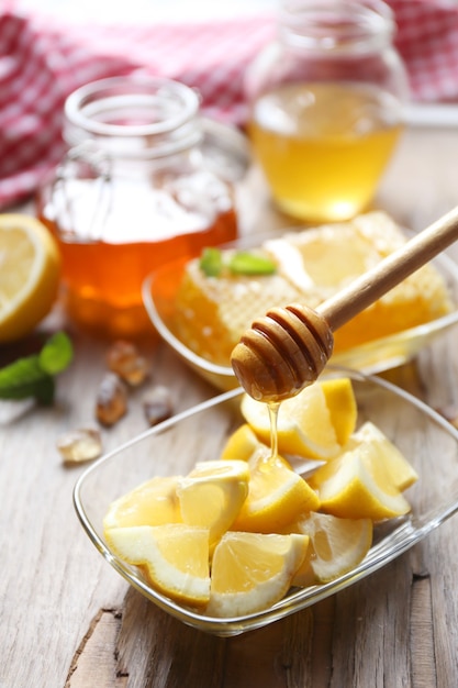 Lemon and honey on wooden table