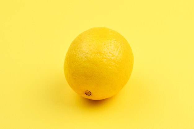 Lemon isolated on yellow background