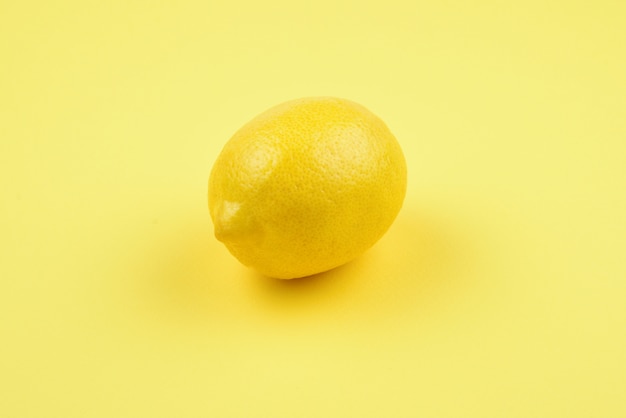 Lemon isolated on yellow background.