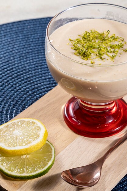 Lemon mousse in crystal bowl with lemon zest.