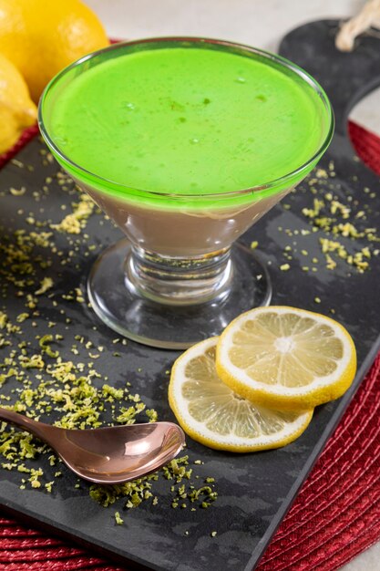 Lemon mousse in glass bowl with lemon gelatin on top.