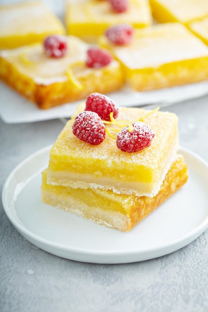 Lemon pie squares topped with rasperries homemade dessert