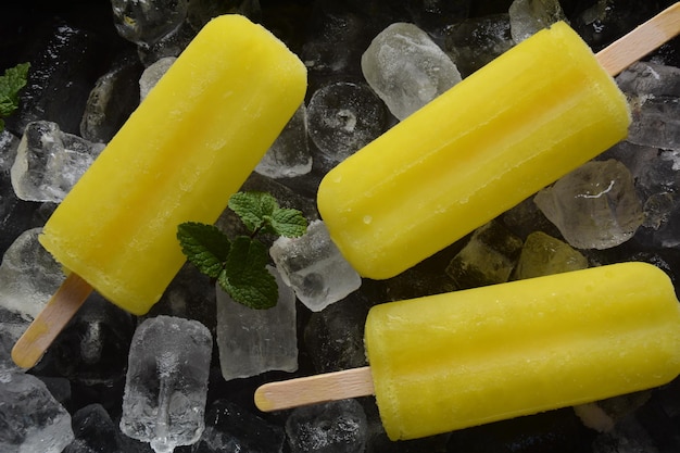 Lemon popsicle on ice background