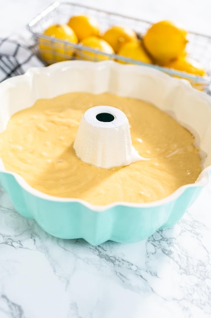 Lemon pound cake batter in a baking bundt pan ready to be baked.