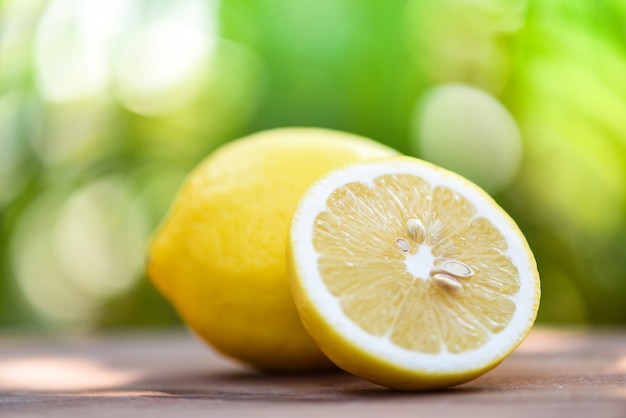 Lemon slice close up and lemon fruit on summer nature background 