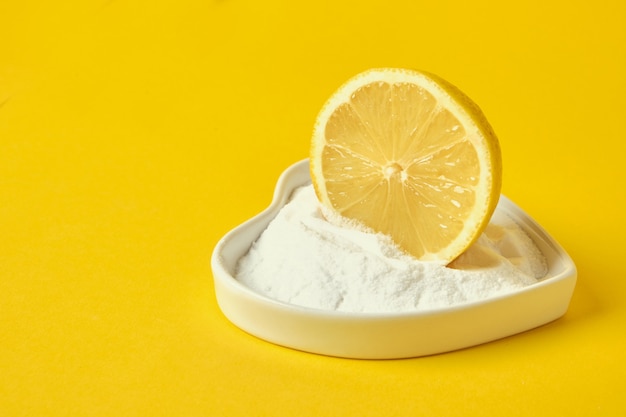 Lemon slice and soda on a yellow background