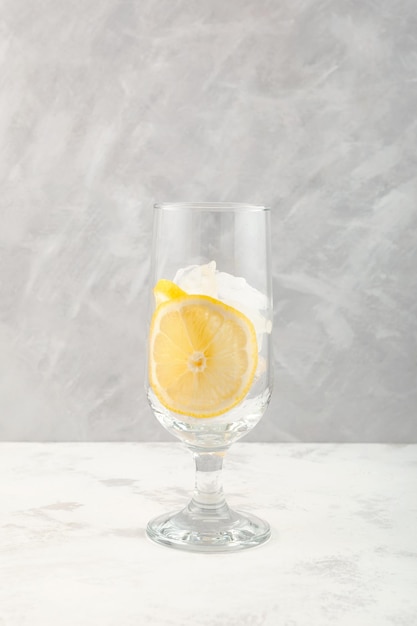 Lemon slices and Ice cubes in drinking glass Serving set for ice cocktail or other refreshing drink