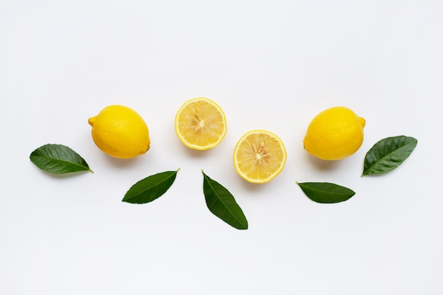 Lemon and slices with leaves isolated on white.