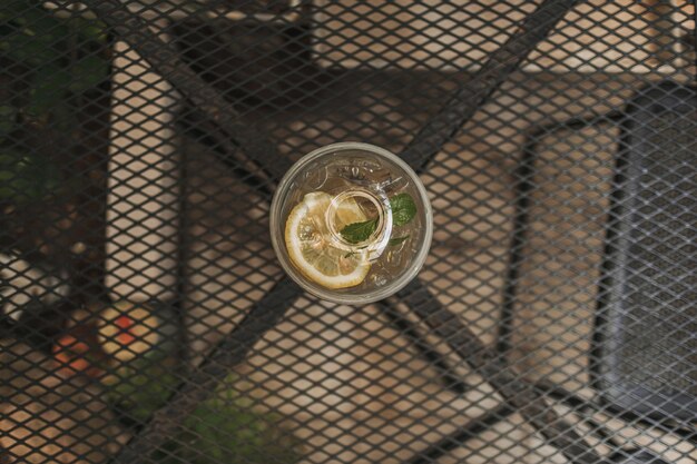 Lemon soda in plastic glass on wooden table in the cafe