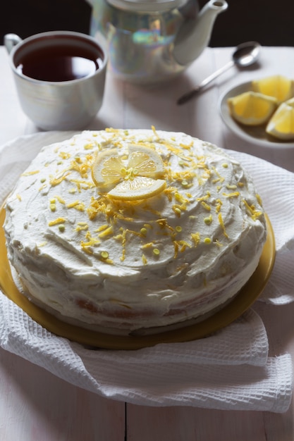 Lemon sponge cake with cream and zest and tea