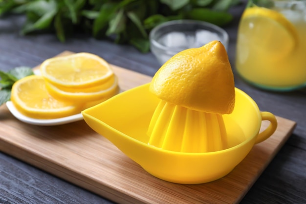 Lemon squeezer on wooden board