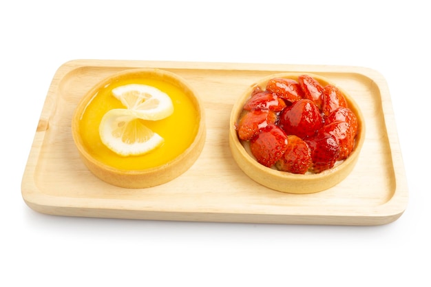 Lemon and Strawberries Tarts topping with lemon and strawberries sliced on white background