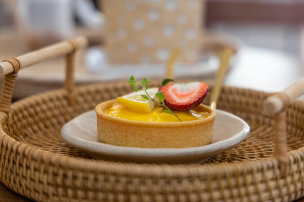 Lemon and strawberry tarts placed on a plate