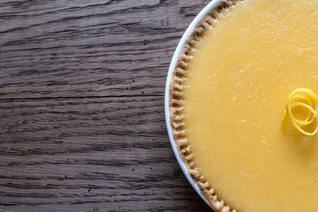 Lemon tart on the wooden background